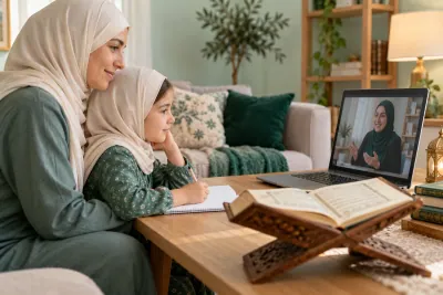 A mother in an ivory hijab and her young daughter, both attentive to a female teacher on a laptop in a calm home study with Quran learning materials
